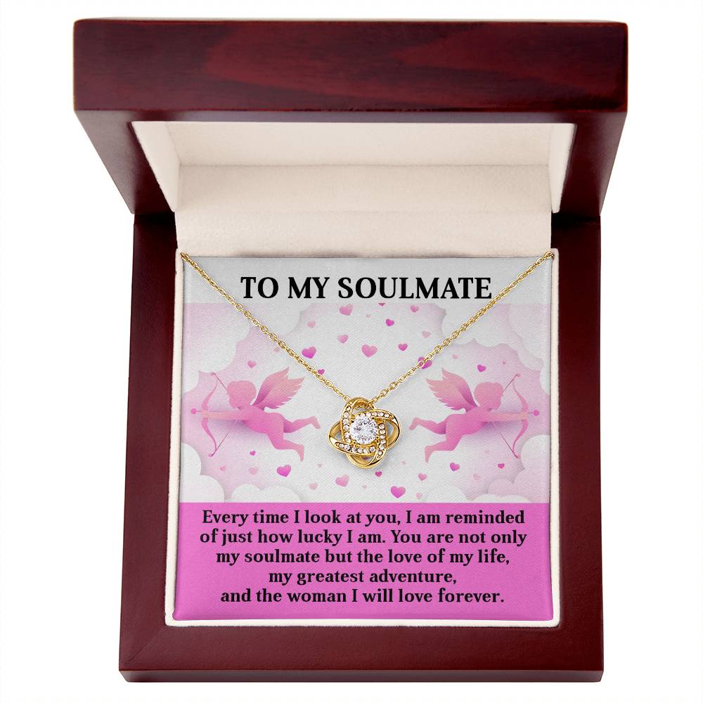 The "Soulmate - Greatest Adventure" Love Knot Necklace, presented in a wooden box with a romantic "To My Soulmate" card featuring angels and hearts, sparkles with cubic zirconia crystals, making it an ideal personalized gift.