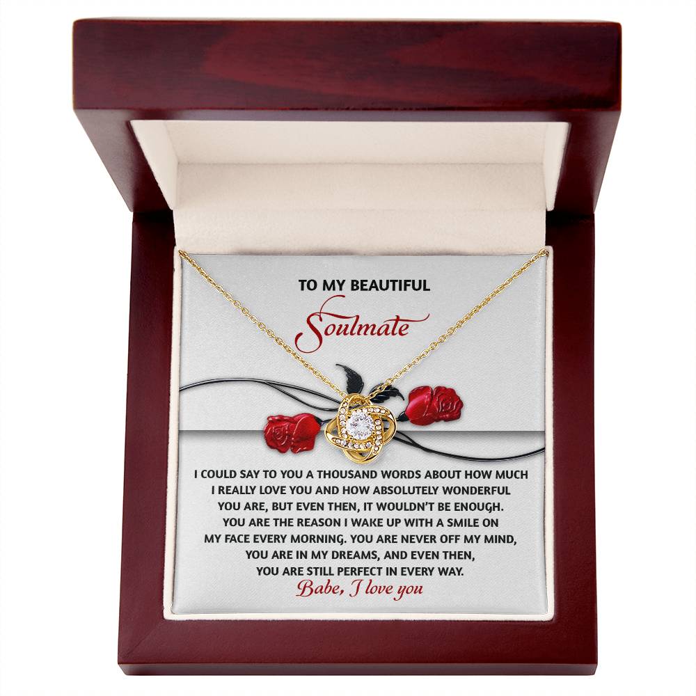The Soulmate-Every Morning - Love Knot Necklace has a gold heart pendant with cubic zirconia crystals in a wooden box. It features a heartfelt message for a "beautiful soulmate" and red rose illustrations, making it the ideal personalized gift.