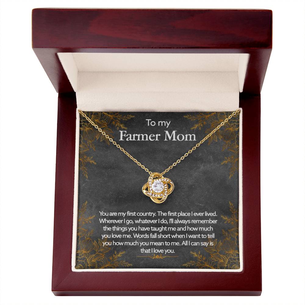 A To My Farmer Mom, You Are My First Country - Love Knot Necklace with a heartfelt message for a 'farmer mom' is displayed inside a ShineOn Fulfillment jewelry gift box.