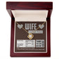 A To Wife, Nutrition Facts - Love Knot Necklace in a gift box that reads, "WIFE I LOVE YOU!" and "Thanks for being awesome!" It humorously lists nutritional facts like "Beauty 1000%" and "Not a significant source of regret," featuring sparkling cubic zirconia crystals with a stunning gold finish.