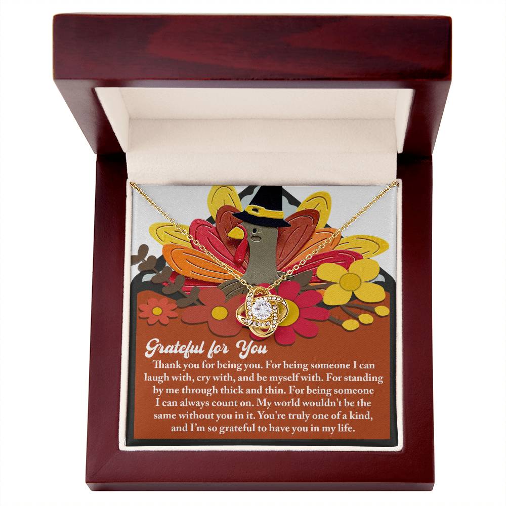 The Thanksgiving-Being You - Love Knot Necklace, beautifully embellished with cubic zirconia crystals, is elegantly presented in a wooden box. Accompanied by a Thanksgiving card showcasing a turkey and sincere words of gratitude, this personalized gift serves as the perfect expression of appreciation.