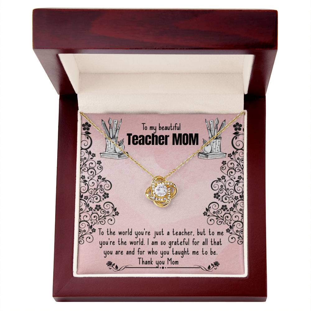 A To My Beautiful Teacher MOM, To The World You're Just A Teacher - Love Knot Necklace with a pendant adorned in cubic zirconia crystals is presented in a red box, featuring an inscription expressing gratitude to a "teacher mom" for her impact and teaching from ShineOn Fulfillment.
