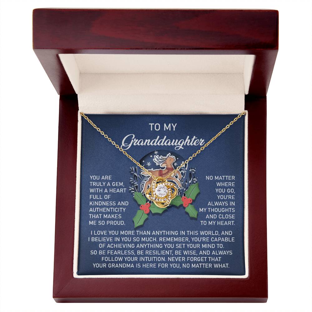 The "Granddaughter-Here For You - Love Knot Necklace" comes carefully placed in a gift box inscribed with "To my Granddaughter." This exquisite piece, crafted from 14k white gold and embellished with cubic zirconia, includes a heartfelt message of love, pride, and encouragement.