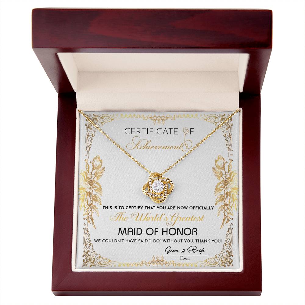 Presenting the "To Maid Of Honor, Certificate Of Achievement - Love Knot Necklace," designed to honor the world's greatest maid of honor. This exquisite necklace, offered in a choice of white gold or yellow gold finish and adorned with shimmering cubic zirconia, represents the heartfelt gratitude of the bride and groom for their invaluable role in the wedding.