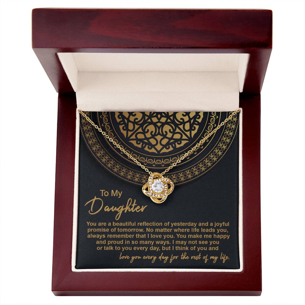 The "To Daughter, Beautiful Reflection 2 - Love Knot Necklace" in 14k white gold is elegantly presented in a black gift box adorned with gold patterns. The box carries the inscription "To My Daughter" along with a heartfelt message expressing love and pride.