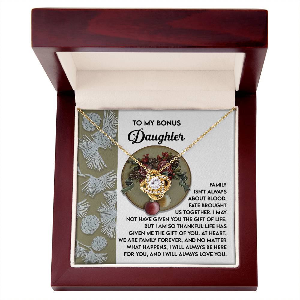 The "Bonus Daughter-Gift Of You - Love Knot Necklace" comes in a box with a heartfelt message for a "bonus daughter," conveying appreciation and love that transcend family boundaries. This personalized gift elegantly symbolizes an unbreakable bond, featuring sparkling cubic zirconia that enhances its charm.