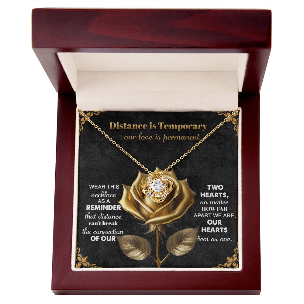 The Soulmate-Love Is Permanent Love Knot Necklace, gold rose with cubic zirconia crystals, is beautifully presented in a wooden box with a touching love and distance message—perfect for your loved one.