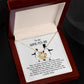 A silver *To Wife-to-be, My Penguin - Love Knot Necklace* with a flower-like pendant is displayed on a jewelry card. The card contains a message to a "Wife-To-Be" featuring a heartfelt dedication and illustrations of two penguins.