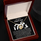 The Sorry-Change The Past 2 - Love Knot Necklace, featuring a heart and knot design adorned with cubic zirconia crystals, is elegantly displayed in a velvet-lined box. The inner lid of the box has an apology message printed on it, making this personalized gift truly special.