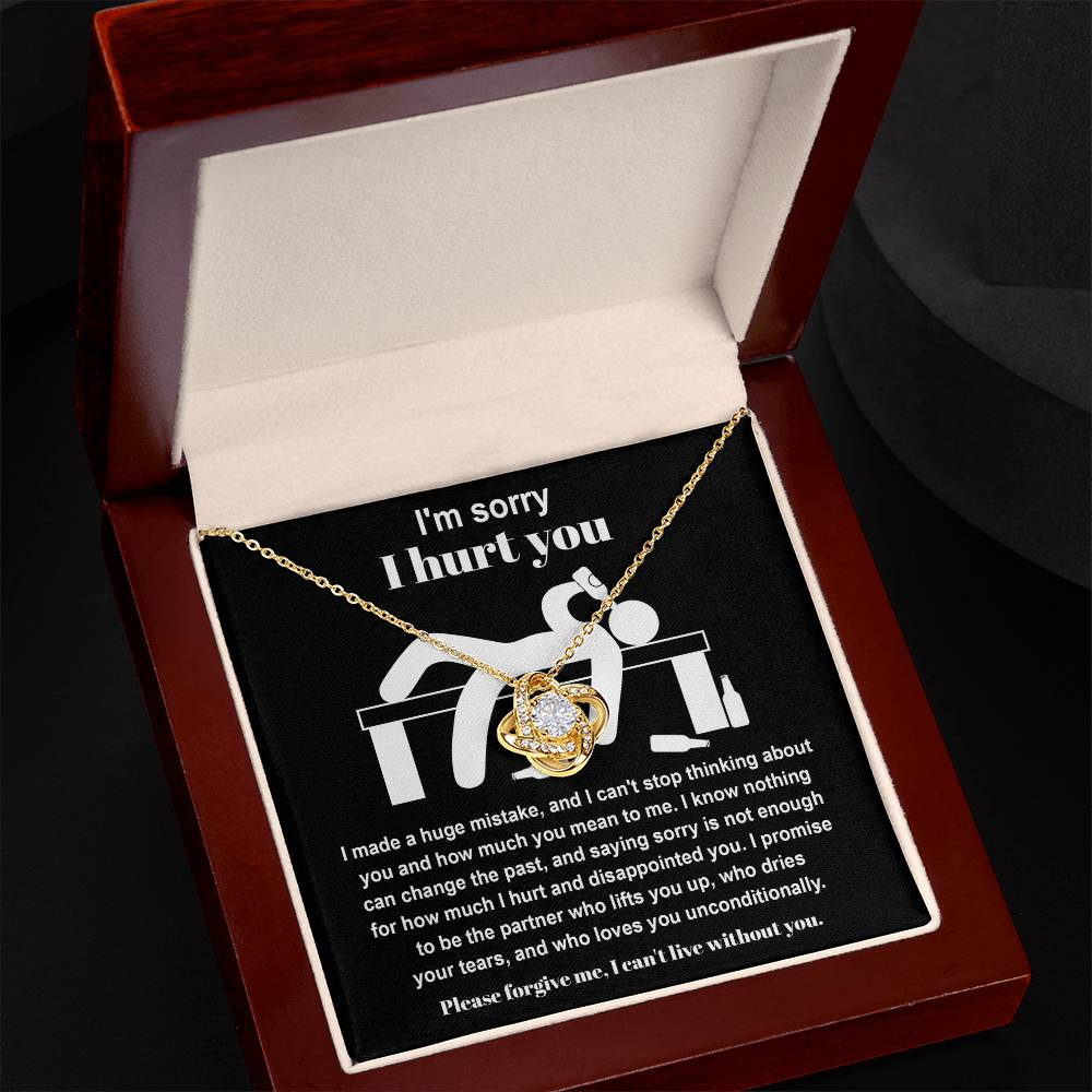 The Sorry-Change The Past 2 - Love Knot Necklace, featuring a heart and knot design adorned with cubic zirconia crystals, is elegantly displayed in a velvet-lined box. The inner lid of the box has an apology message printed on it, making this personalized gift truly special.