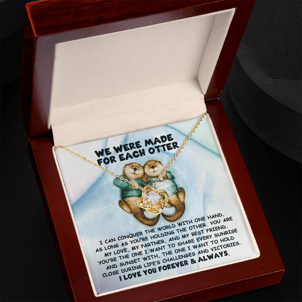 The Soulmate- For Each Otter - Love Knot Necklace, showcasing intertwined hearts and presented on a card with an otter couple alongside a touching message about love and support, is elegantly packaged in a wooden box.