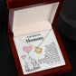 An open jewelry box with a "To Mama To Be, All Your Heart" Love Knot Necklace from ShineOn Fulfillment on a chain; the box has a sentimental message addressed to "mommy" from an unborn child.