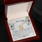 A "Sorry-Made A Mistake - Love Knot Necklace" features a box with a heartfelt apology message. The white gold finish and cubic zirconia crystals shimmer, as the text expresses deep regret and sorrow for causing hurt, describing the actions as pathetic, cowardly, and selfish, pleading for forgiveness.