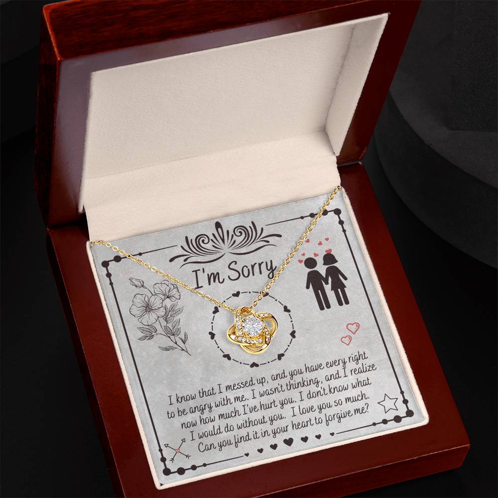 The "Sorry-I Would Do - Love Knot Necklace" is a personalized gift box that includes an apology message and a Love Knot Necklace adorned with cubic zirconia crystals. The box features the phrase "I'm Sorry" above illustrations of flowers and a couple, expressing regret for a mistake and seeking forgiveness.