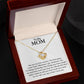 A To My Mom, You Are My First Country - Love Knot Necklace with cubic zirconia crystals is displayed inside an open jewelry box with a printed message addressed to 'my mom', expressing love and gratitude. The necklace is from ShineOn Fulfillment.