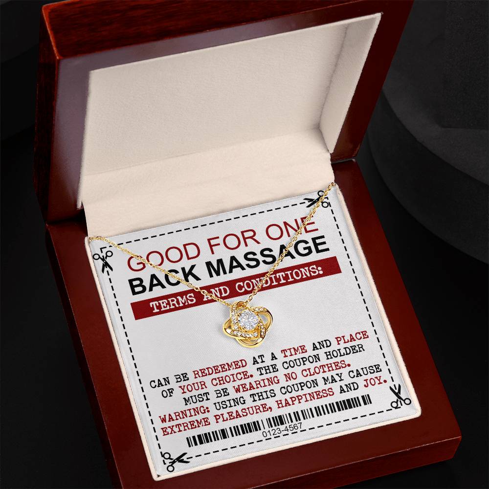 A silver To Wife, Back Massage - Love Knot Necklace with a pendant rests on a voucher stating it is good for one back massage, with conditions including choosing the time and place, and the coupon holder must be unclothed.