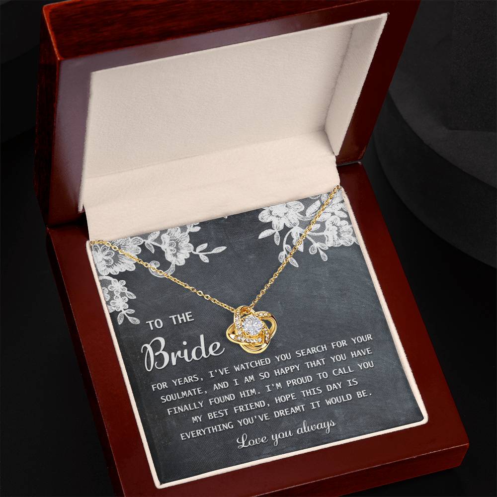 The "To Bride, My Best Friend - Love Knot Necklace" in silver, adorned with cubic zirconia crystals, is presented on a card with a sentimental message for the bride and comes in a decorated gift box.