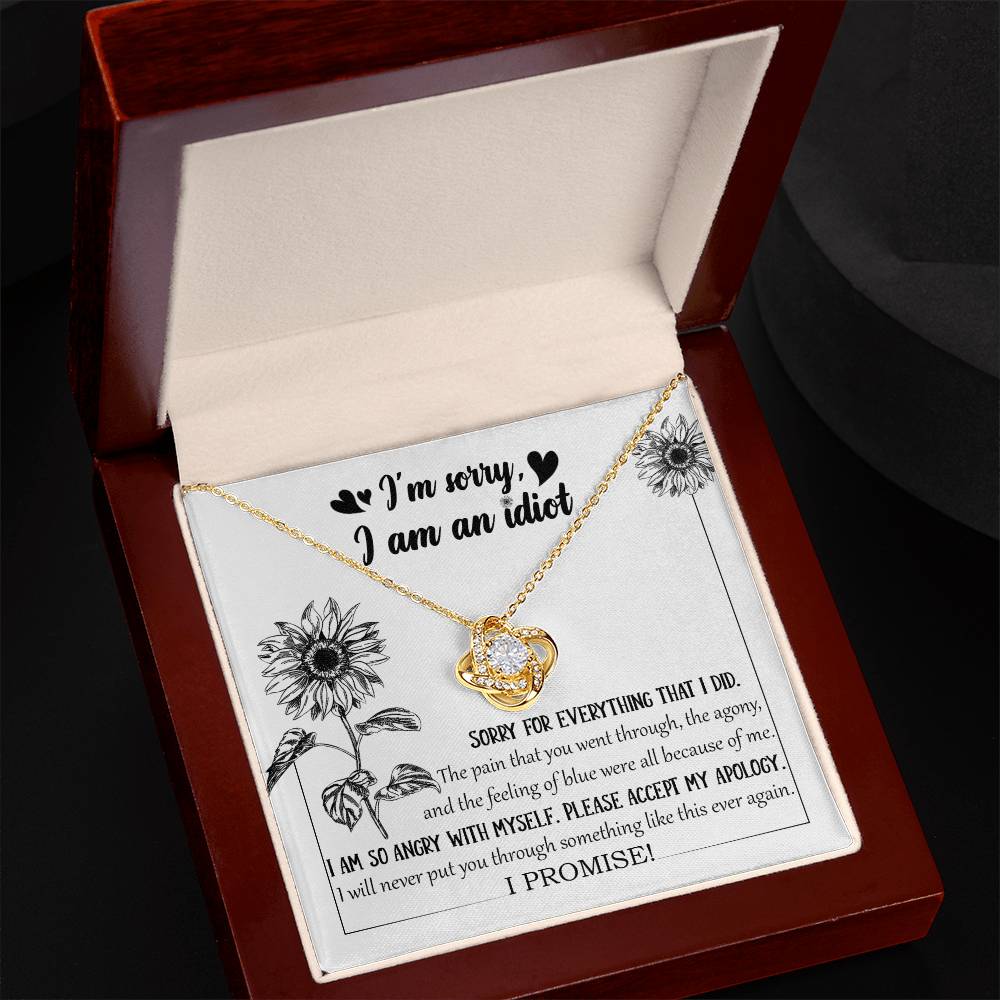 The Sorry-Feeling Of Blue - Love Knot Necklace, crafted from 14k white gold with a heart-shaped pendant adorned with cubic zirconia crystals, is displayed in a box containing an apology message, "I'm sorry, I am an idiot," along with additional text expressing regret for causing pain and a promise to not repeat the hurt.