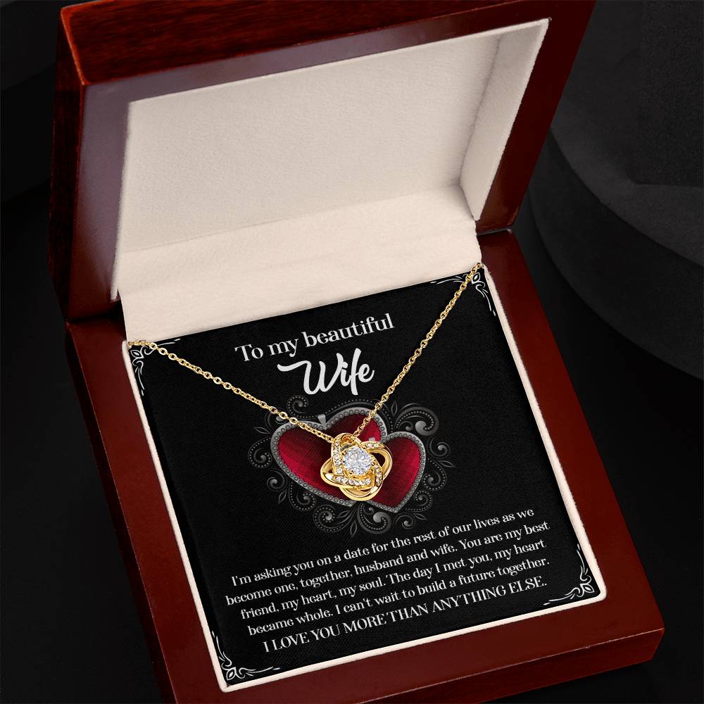 A To Wife, Heart Became Whole - Love Knot Necklace in a gift box, adorned with sparkling cubic zirconia crystals and accompanied by a heartfelt message for a wife, expressing love and a desire to build a future together.