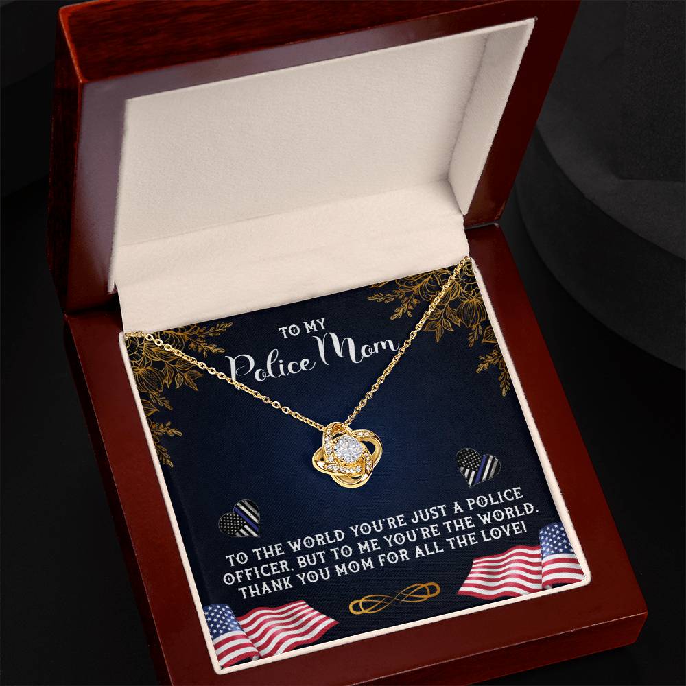 A To My Police Mom, To The World You're Just A Police Officer Love Knot Necklace by ShineOn Fulfillment is displayed inside an open jewelry box, which bears an inscription dedicating the piece of jewelry to "my police mom" and expressing gratitude and love.
