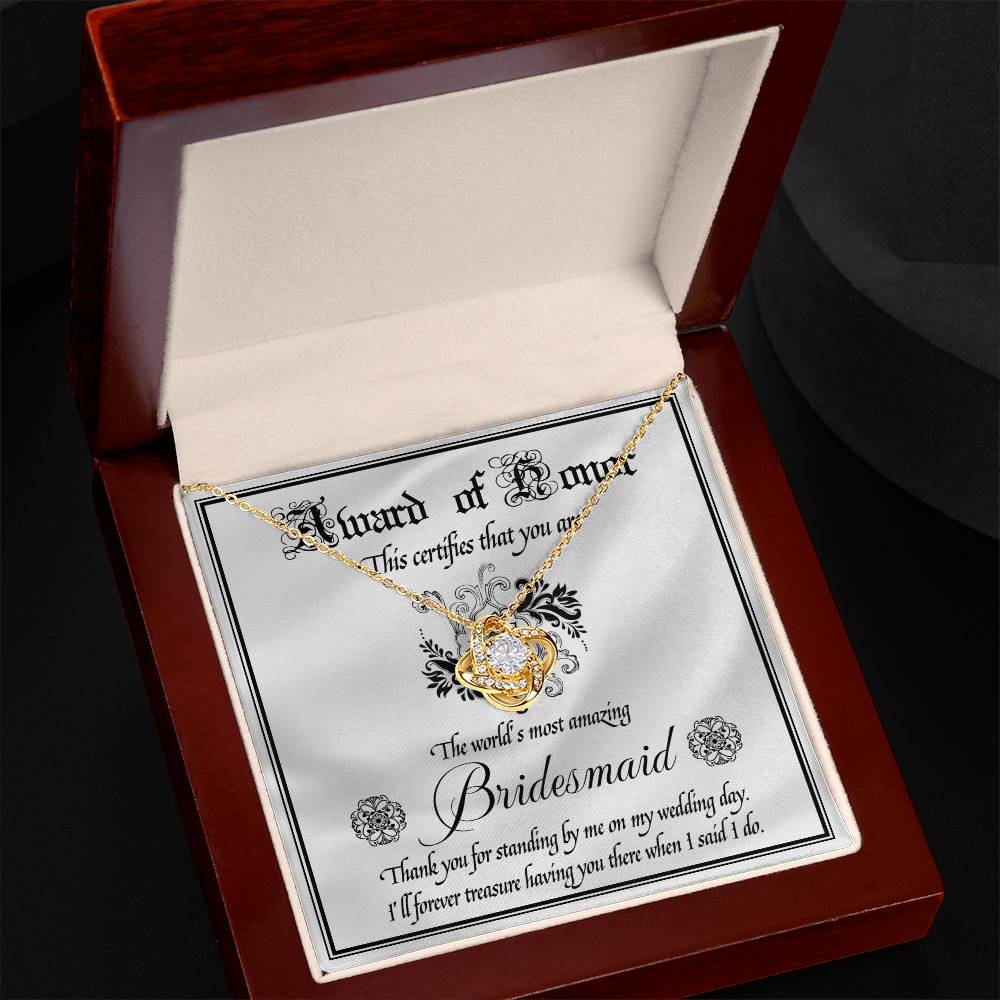 Introducing the "To Bridesmaid, Award Of Honor - Love Knot Necklace," a decorative certificate thanking the world's most amazing bridesmaid for her support on the wedding day. Featuring a Love Knot Necklace adorned with cubic zirconia crystals, this personalized gift is a heartfelt token of appreciation and love.