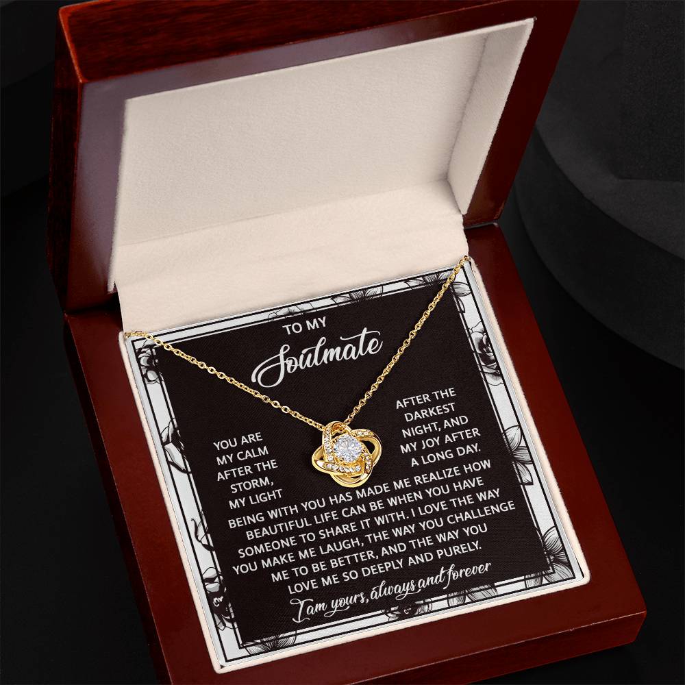 The Soulmate-Deeply And Purely - Love Knot Necklace features an intertwined heart pendant with sparkling cubic zirconia, nestled in an open jewelry box. The message conveys love and devotion, ending with "I am yours, always and forever," making it an ideal personalized gift.