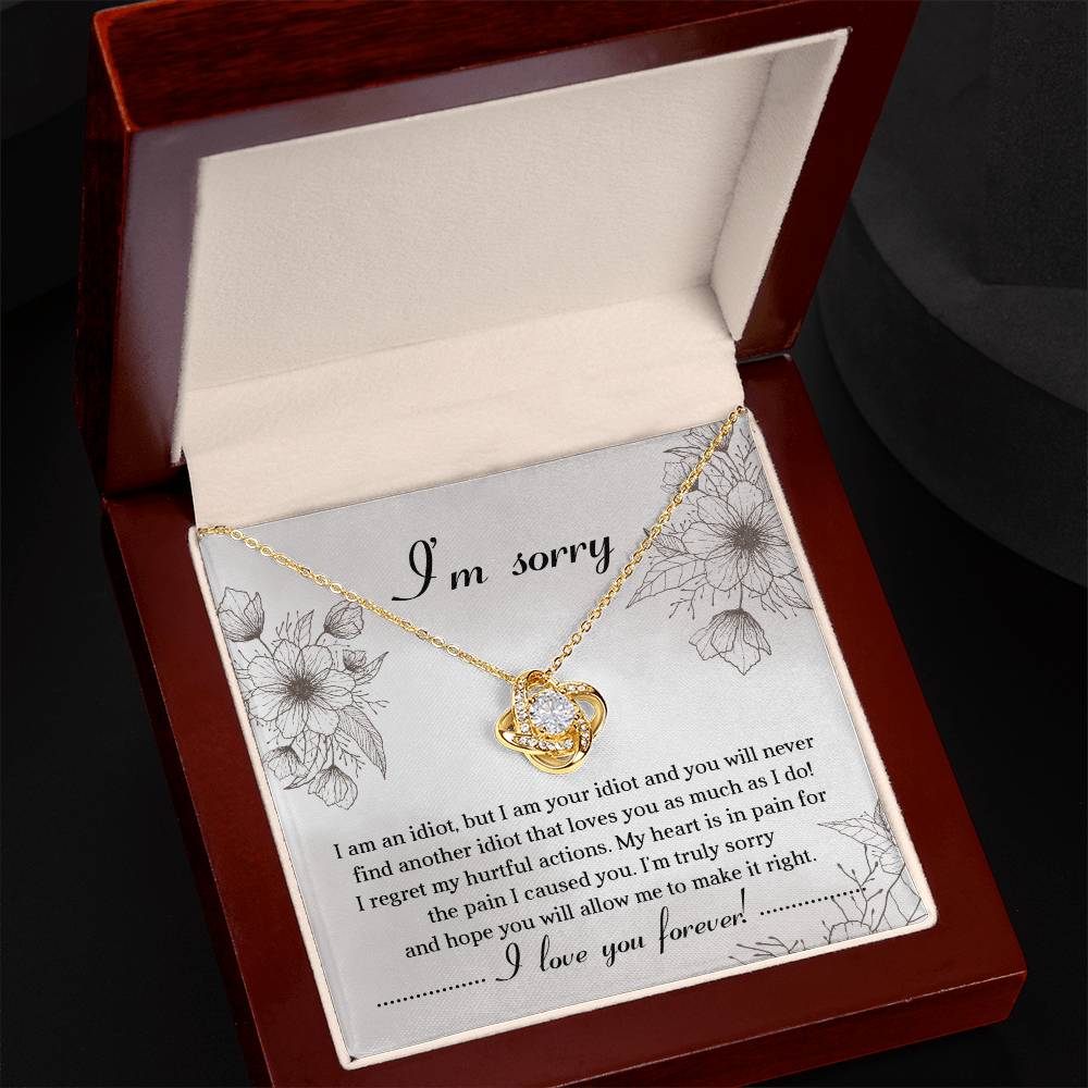 The Sorry-For The Pain - Love Knot Necklace is a personalized gift featuring a love knot pendant adorned with cubic zirconia crystals, presented on a card with an apology message expressing regret and a heartfelt plea for forgiveness, ending with "I love you forever!