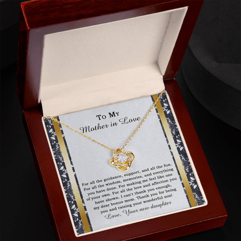 The "To Mother-in-law, Of Your Own - Love Knot Necklace" features a heart-shaped pendant adorned with cubic zirconia crystals, and it comes on a card expressing gratitude for a mother-in-law's love and support.