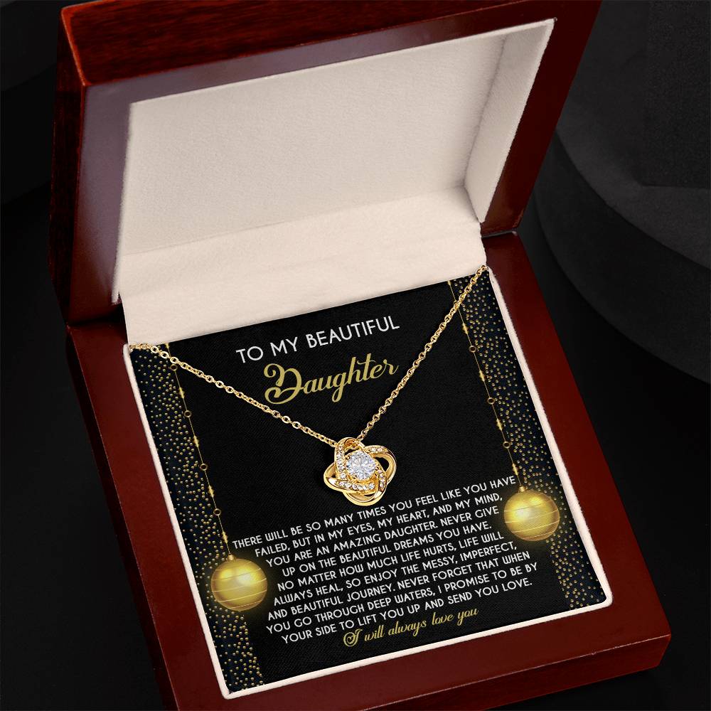 The Daughter-Deep Waters - Love Knot Necklace, adorned with shimmering cubic zirconia crystals and nestled in a wooden box engraved with a heartfelt message for your daughter, makes for the perfect personalized gift.