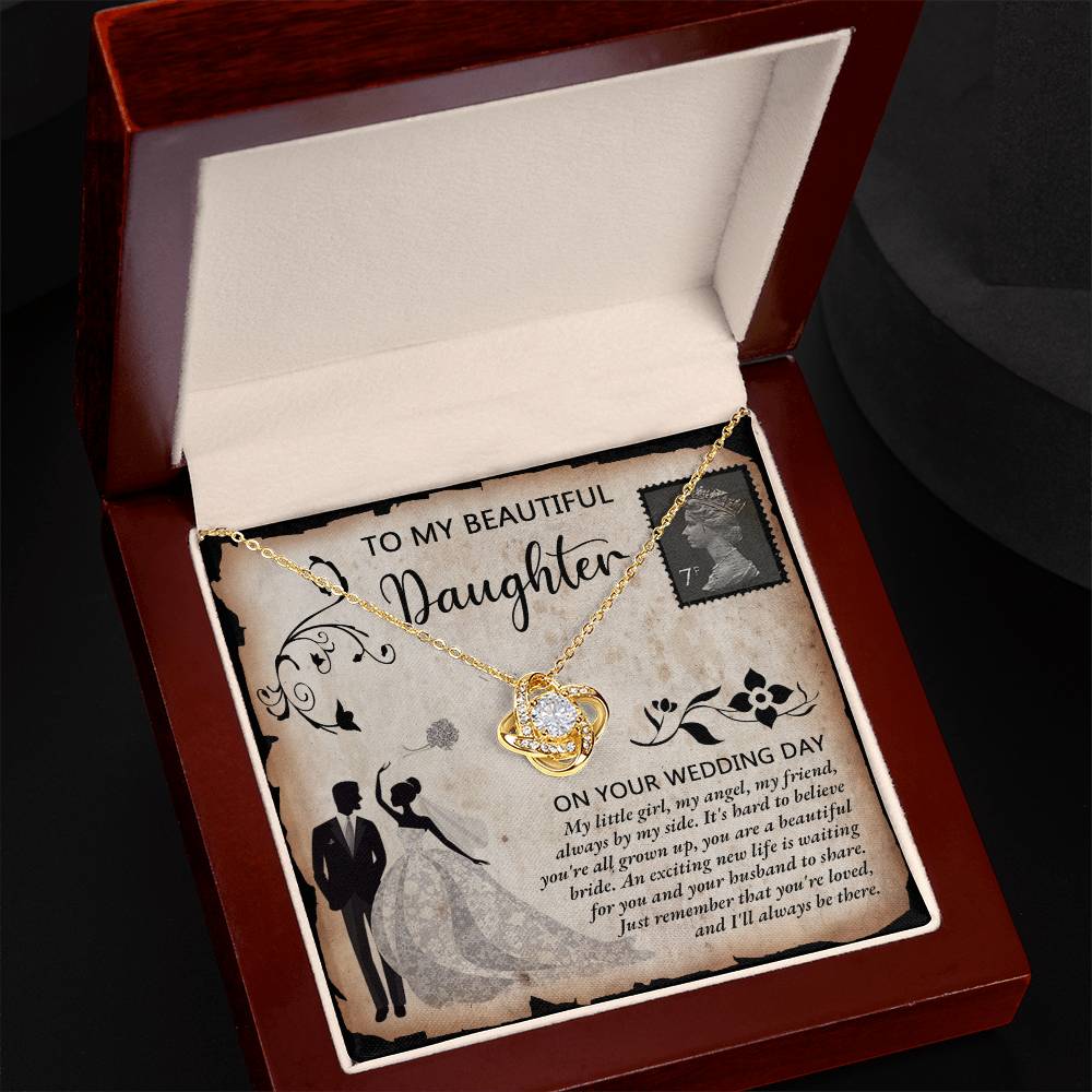 A silver To Daughter Wedding, Beautiful Bride - Love Knot Necklace adorned with cubic zirconia crystals on a card featuring an illustrated bride and groom. The card reads "To my beautiful daughter on your wedding day" with a heartfelt message.