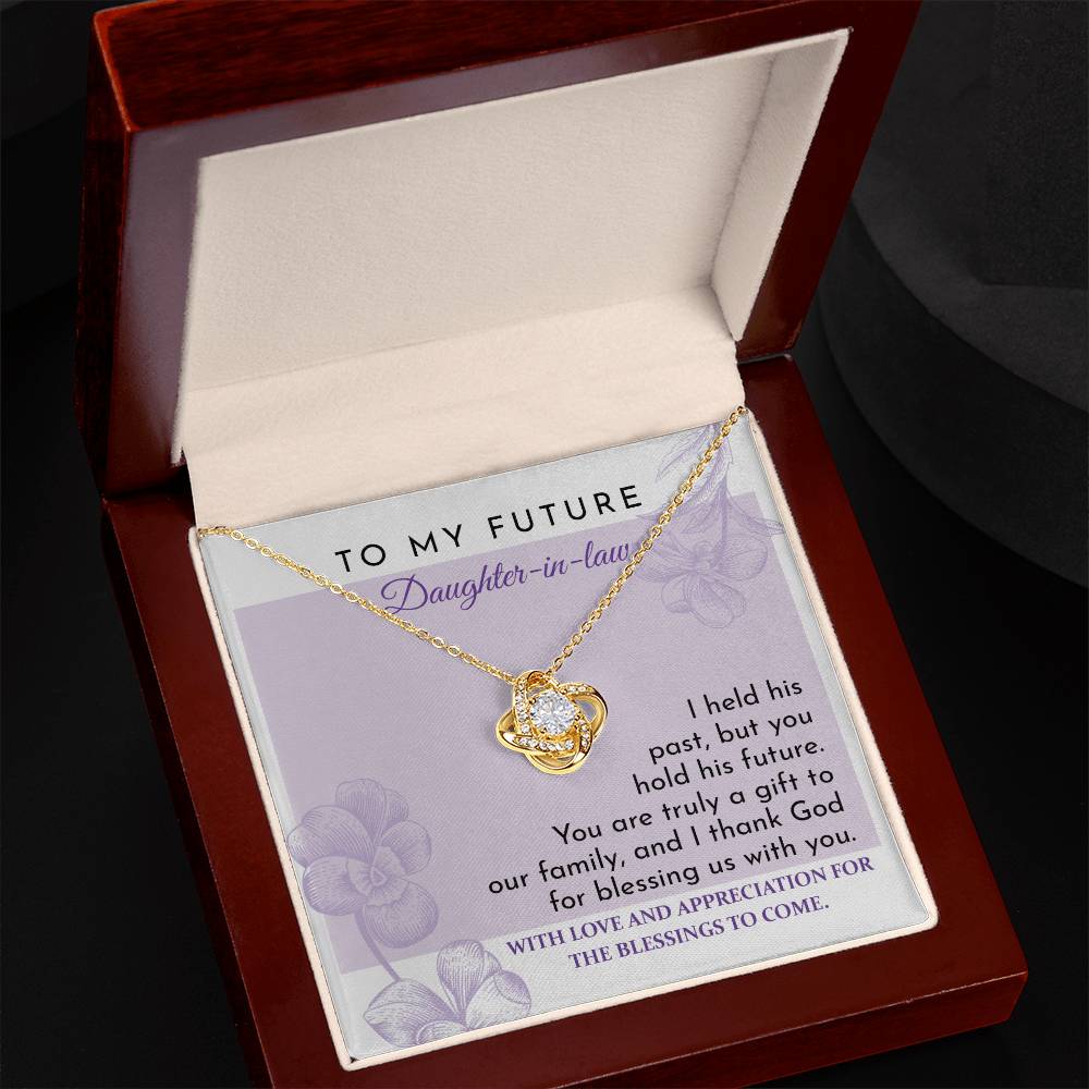 To Daughter-in-law, A Gift - Love Knot Necklace with an intertwined pendant, set against a card reading "To My Future Daughter-in-law," and an appreciation message expressing gratitude and blessings for the future. Decorated with shimmering cubic zirconia, this piece is a glowing testament to your welcome into the family.