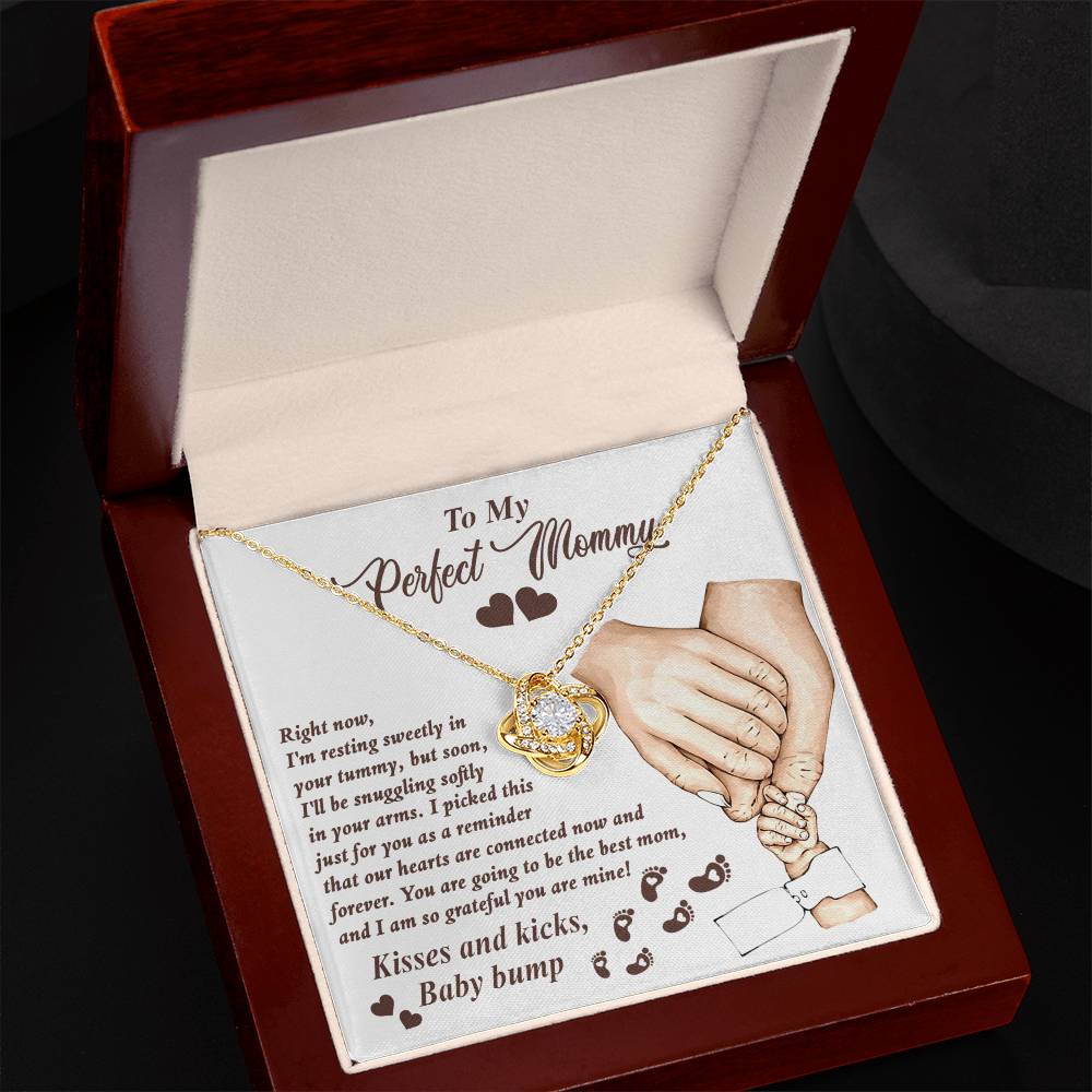A heart-shaped ShineOn Fulfillment Love Knot Necklace with an inscribed message for an expectant mother, presented in an open gift box.