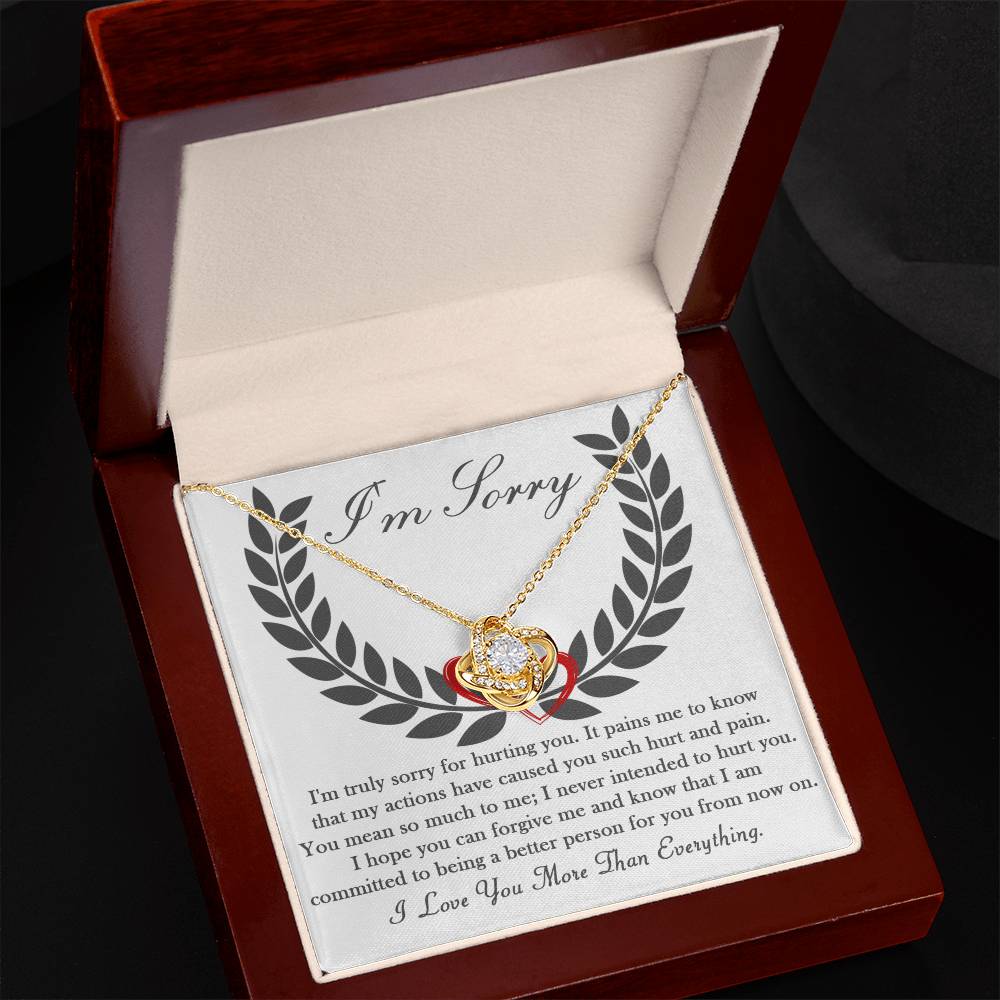 The "Sorry-From Now On" Love Knot Necklace features sparkling cubic zirconia crystals set in 14k white gold, elegantly presented in a wooden gift box that displays an apology message along with the heartfelt words, "I Love You More Than Everything.