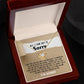 The Sorry-Keep Me Apart - Love Knot Necklace features a gold Love Knot design with a flower pendant, presented in a box adorned with cubic zirconia crystals. Inside the box, you'll find a heartfelt, personalized message expressing sincere apology and a deep desire for forgiveness.