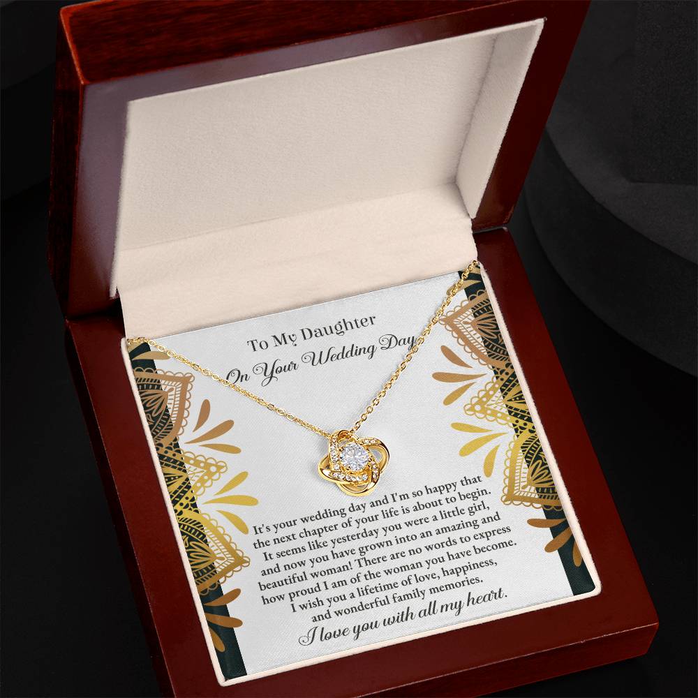 The "To Daughter, Wedding - A Little Girl - Love Knot Necklace" adorned with cubic zirconia crystals is elegantly showcased in a box containing a heartfelt message for a daughter on her wedding day. The text conveys love, pride, and best wishes for a joyful marriage, beautifully accentuated by the option of a white gold or yellow gold finish.