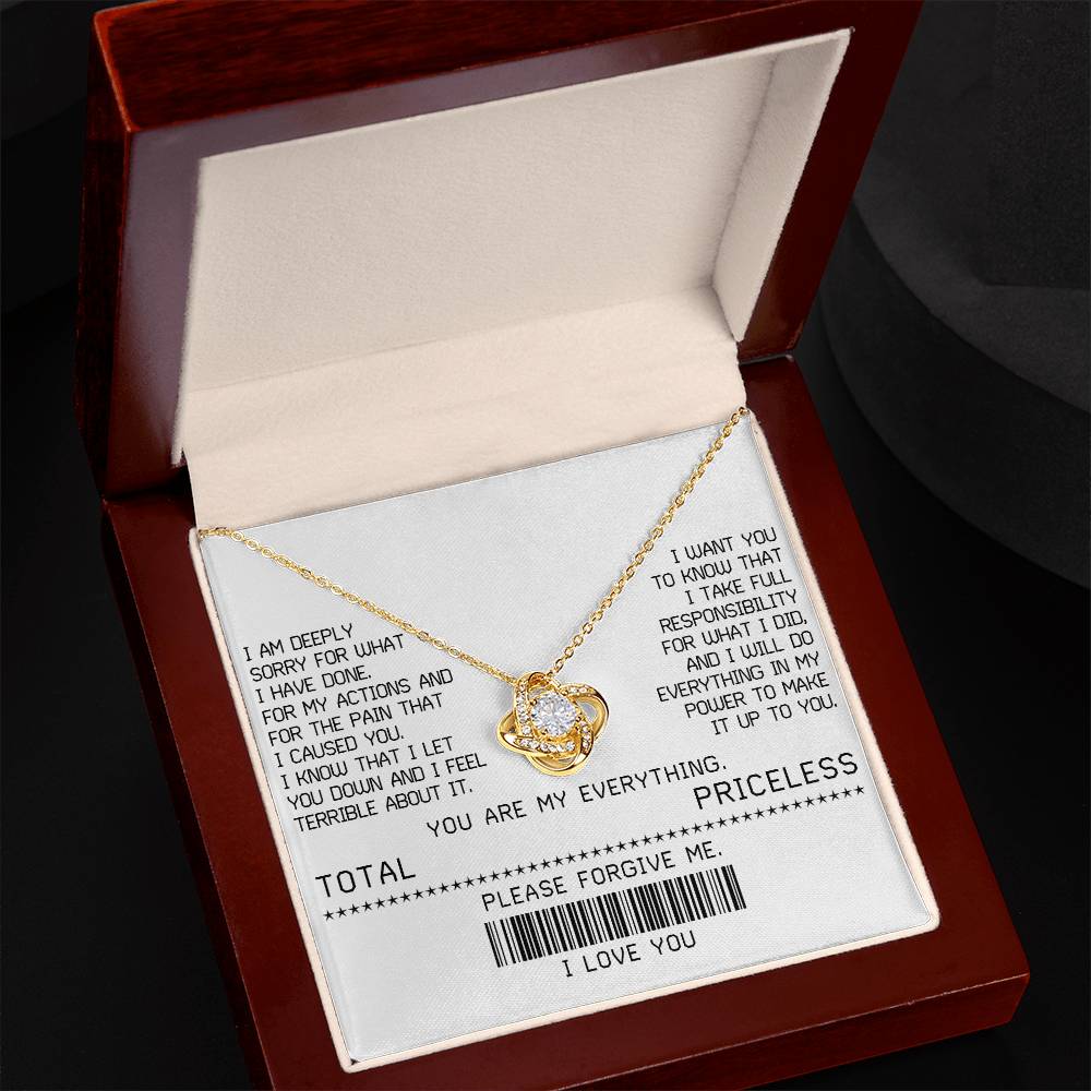 The Sorry-Make It Up - Love Knot Necklace, featuring a white gold finish and adorned with shimmering cubic zirconia crystals, is beautifully presented on a card with an apology message. This card includes phrases such as "TOTAL PRICELESS," "PLEASE FORGIVE ME," and "I LOVE YOU," along with a barcode, making it the perfect elegant touch for your sincere apology.