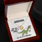 A bridesmaid proposal necklace box featuring a dinosaur with a veil and a stunning To Bridesmaid, Will You Be - Love Knot Necklace in white gold. The text reads, "There's a 90% chance I won't be a bridezilla. Will you be my bridesmaid?