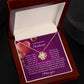 The Soulmate-My Soul Love Knot Necklace features intertwined hearts and sparkling cubic zirconia crystals, nestled in a jewelry box. Inside, a card expresses romantic sentiments about love, loyalty, and gratitude.