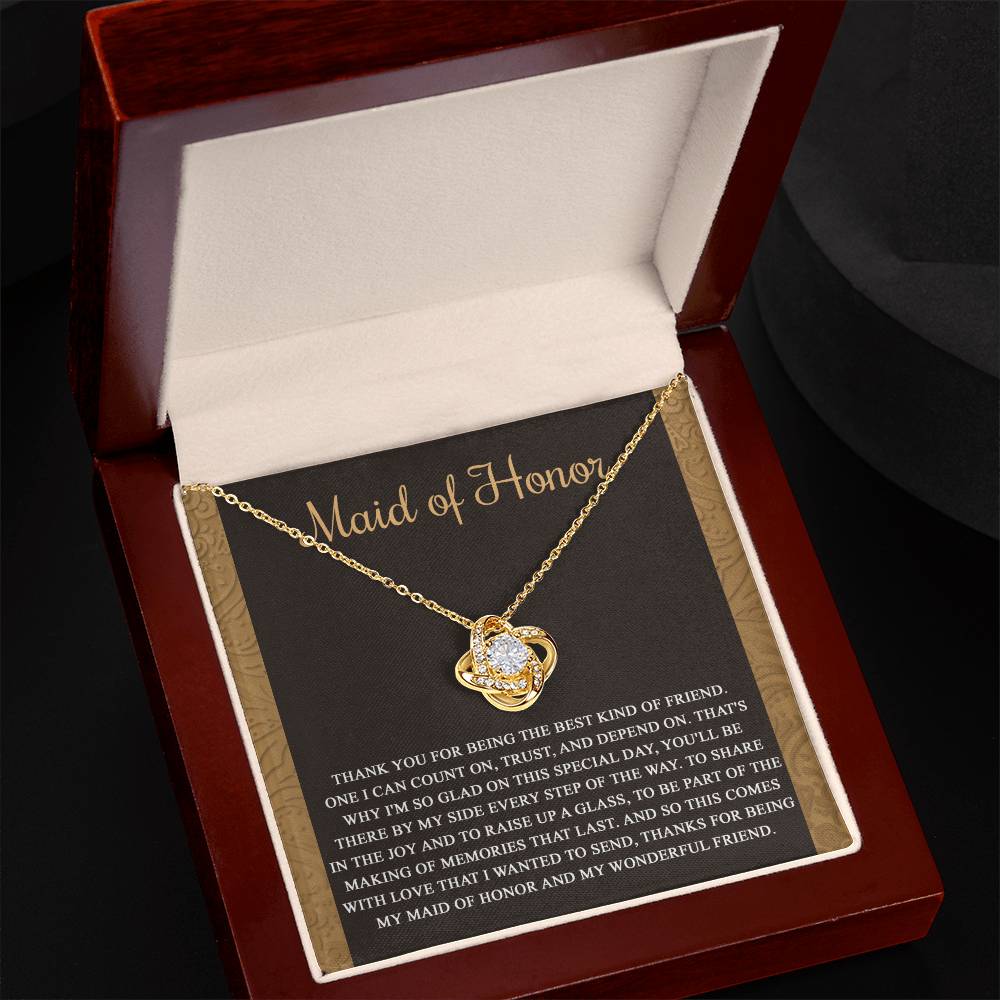 The "To Maid of Honor, Kind Of Friend - Love Knot Necklace" features an intertwined knot design adorned with cubic zirconia crystals on a background that reads "Maid of Honor," followed by a heartfelt thank you message to the maid of honor.