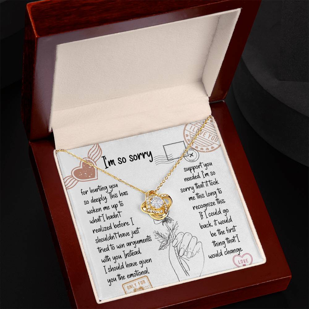 The Sorry-Emotional Support - Love Knot Necklace, featuring an intertwined knot pendant adorned with cubic zirconia crystals, is displayed on a card with an apology message expressing regrets and promising better emotional support in the future.