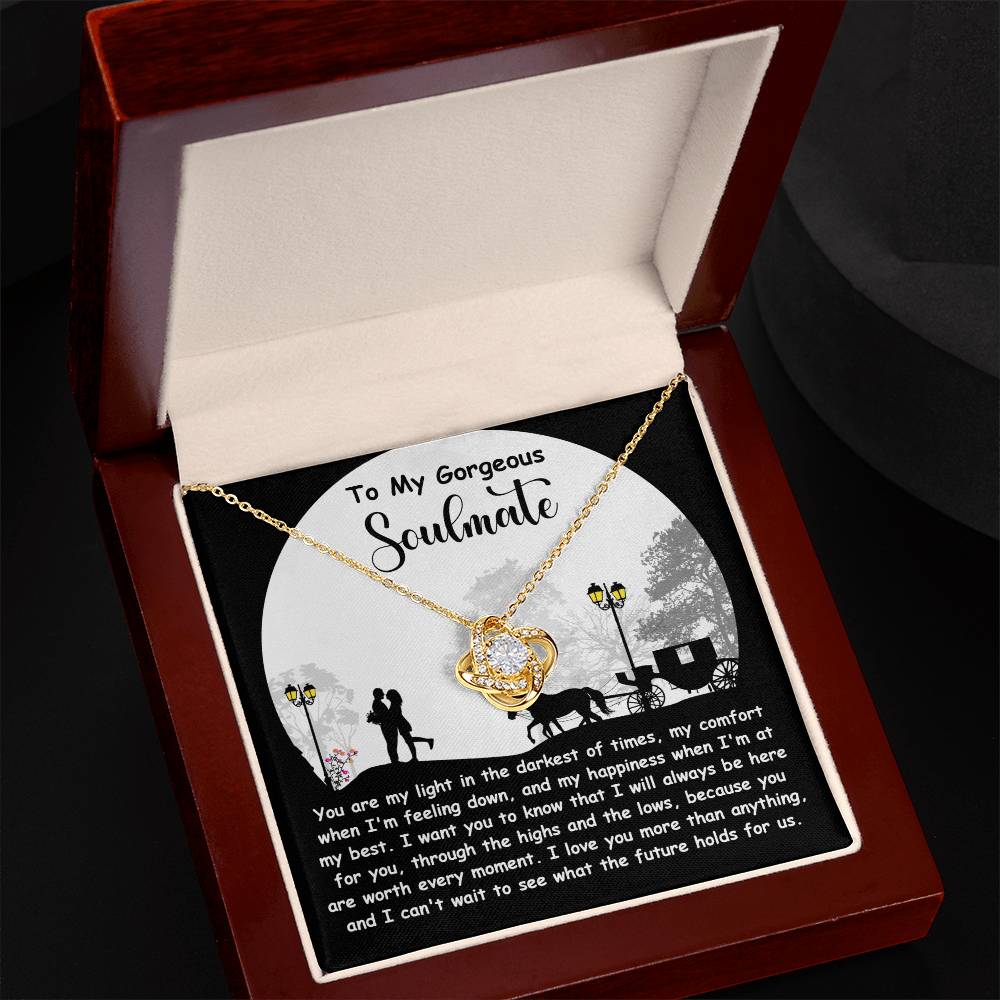 The Soulmate-Holds For Us - Love Knot Necklace comes in a wooden box with a message card saying, "To My Gorgeous Soulmate," and features a couple's silhouette under a streetlamp. This cubic zirconia piece symbolizes an unbreakable bond.