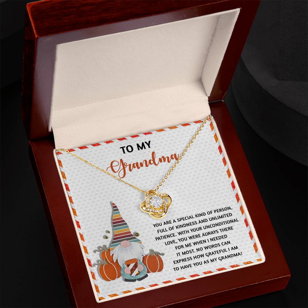 This customized Grandma-Needed It Most - Love Knot Necklace showcases interlocking hearts adorned with cubic zirconia and is elegantly presented in a box featuring a gnome-themed message for grandma.