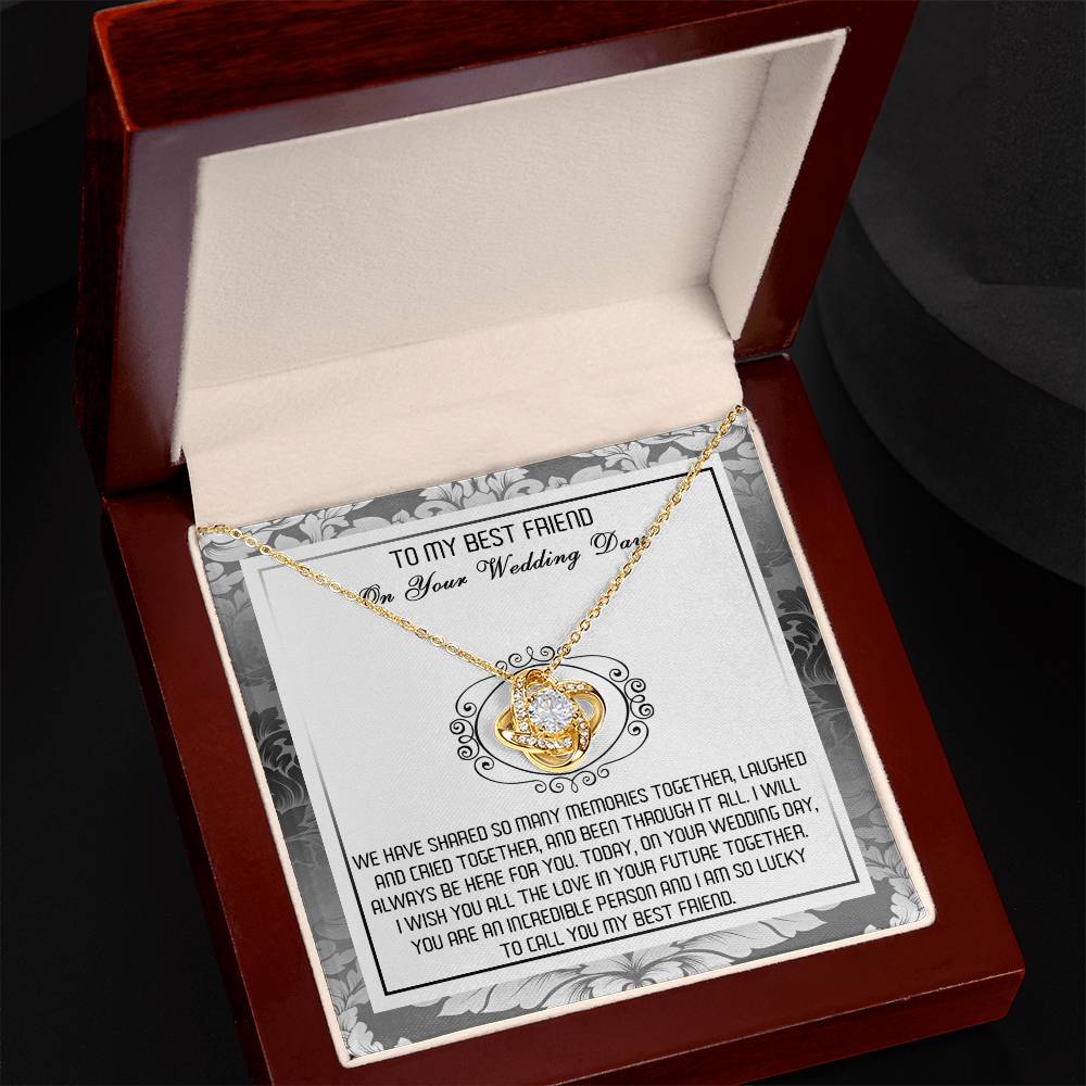 A decorative box containing the "To Best Friend, An Incredible Person - Love Knot Necklace," crafted in 14k white gold with an intricate pendant adorned with cubic zirconia crystals and a heartfelt message titled "To My Best Friend On Your Wedding Day.