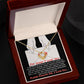 A Sorry-Without Thinking - Love Knot Necklace with a white gold finish and diamond pendant rests in an open jewelry box. Inside the lid is an apology letter printed in red and white text, enhancing the heartfelt presentation.