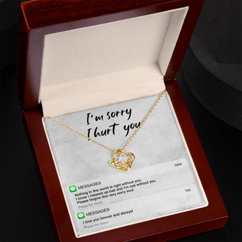 Image of the Sorry-Lost Without You - Love Knot Necklace with a diamond pendant against a background with the text "I'm sorry I hurt you." Below are text messages reading "Nothing in this world is right without you... Please forgive this very sorry soul." and "I love you forever and always!