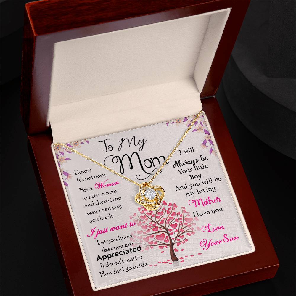 A To My Mom, I Know Its Not Easy - Love Knot Necklace with a gold finish and a heart-shaped cubic zirconia pendant presented in a box with a sentimental message from ShineOn Fulfillment.