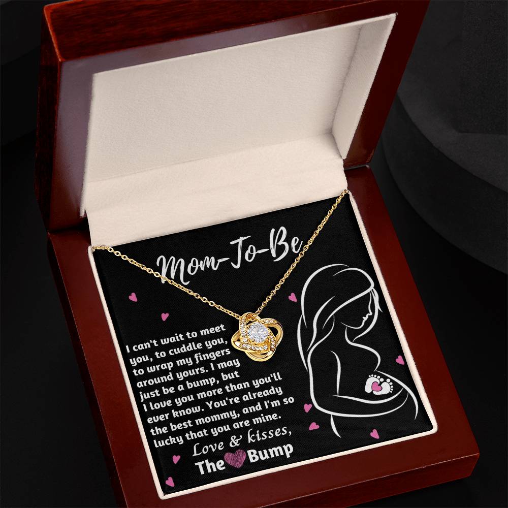A To Mama To Be, The Best Mommy - Love Knot Necklace with a "mom-to-be" pendant presented in a box with an affectionate message for an expectant mother from 'the bump' by ShineOn Fulfillment.