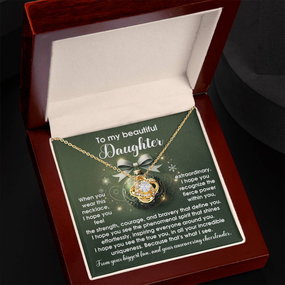 The Daughter-Incredible Uniqueness - Love Knot Necklace features a heart-shaped pendant elegantly displayed in an open jewelry box. The box contains a heartfelt message for a daughter, making it the perfect personalized gift, complemented by premium cubic zirconia for added elegance and sparkle.