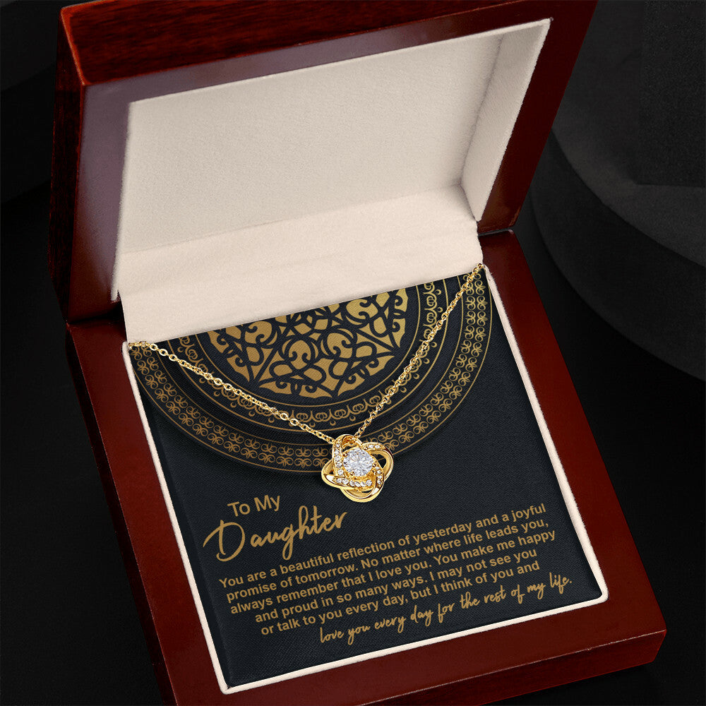 The "To Daughter, Beautiful Reflection 2 - Love Knot Necklace" in 14k white gold is elegantly presented in a black gift box adorned with gold patterns. The box carries the inscription "To My Daughter" along with a heartfelt message expressing love and pride.