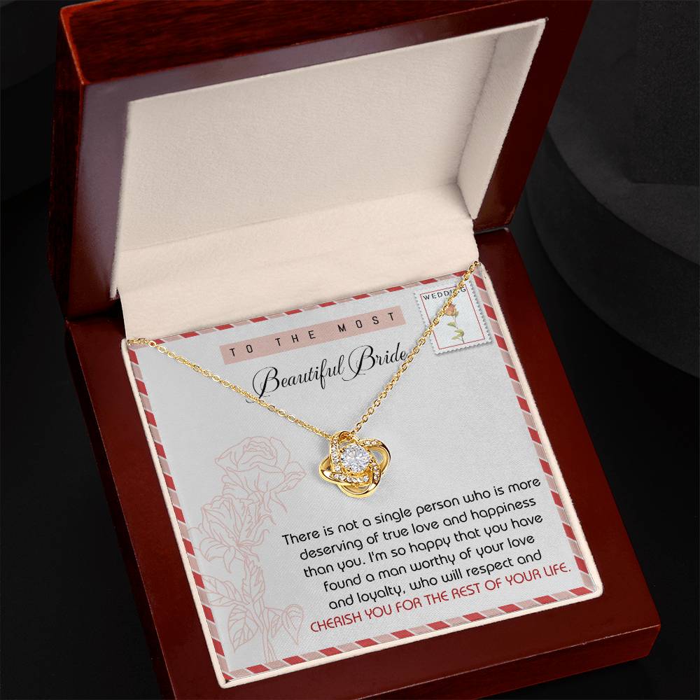 The "To Bride, Of Your Life - Love Knot Necklace," adorned with cubic zirconia crystals, comes in a display box complete with a heartfelt message card for the bride.